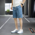 Casual loose-fit beach shorts in green with a straight cut and elasticated waistband