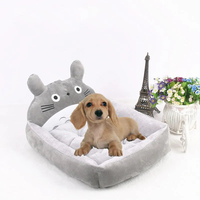 Blue cartoon-style washable pet bed with raised sides and soft fleece interior for small dogs or cats.