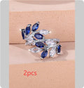 Adjustable copper leaf-shaped ring with zircon stones in various colour options on a white background.