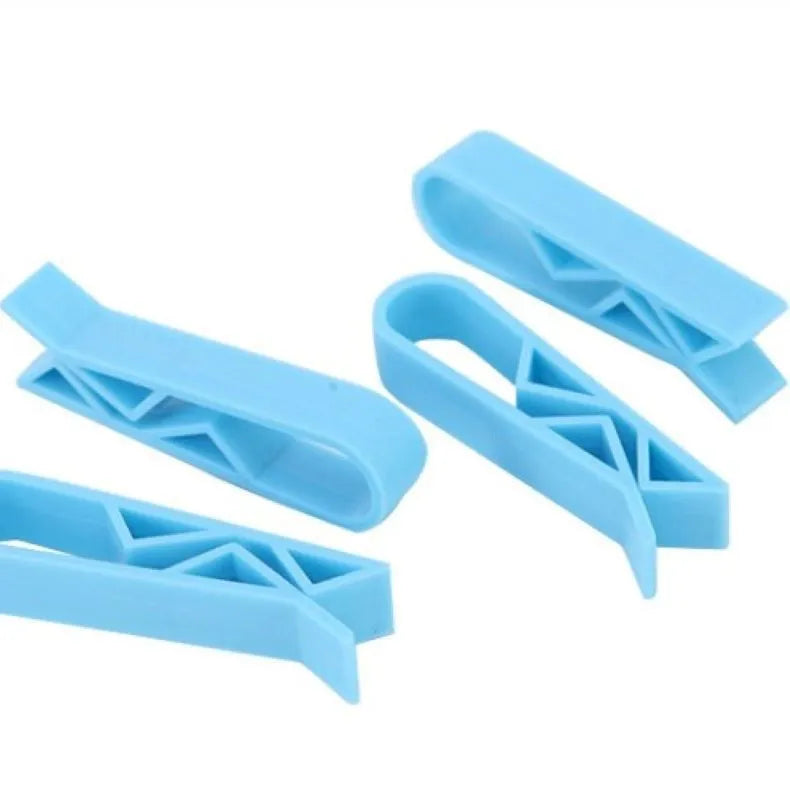 Green and black non-slip plastic clip for holding a bin bag on a wheelie bin rim.