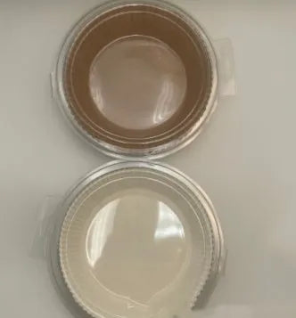 Round white disposable parchment paper liner for air fryer basket with raised edges.