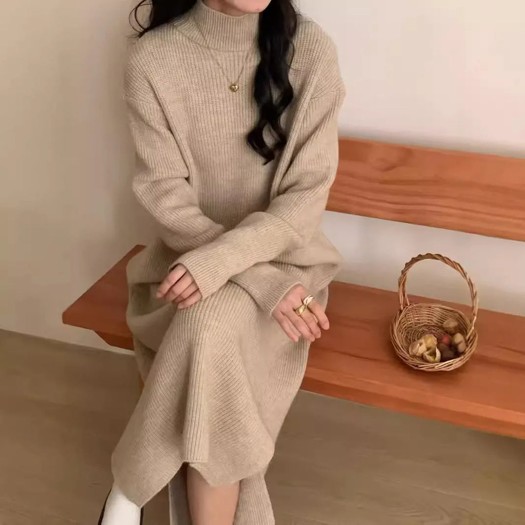 Woman wearing a milky white half turtleneck acrylic knit dress with a high waist and overknee A-line skirt.