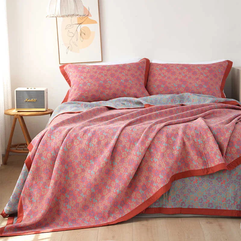 Three-piece cotton gauze bed blanket set with botanical floral pattern showing blanket and two pillowcases