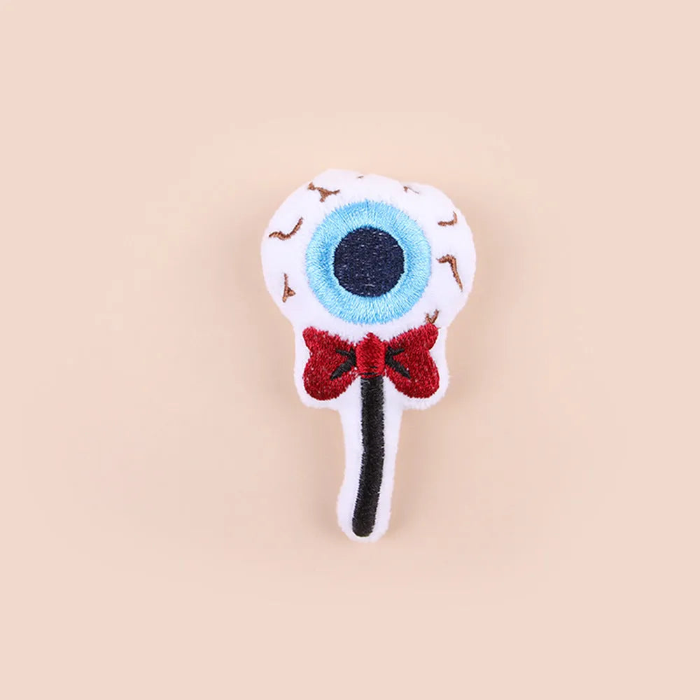 Small plush cat teaser toy with candy, eyes or skull design and feather attachment