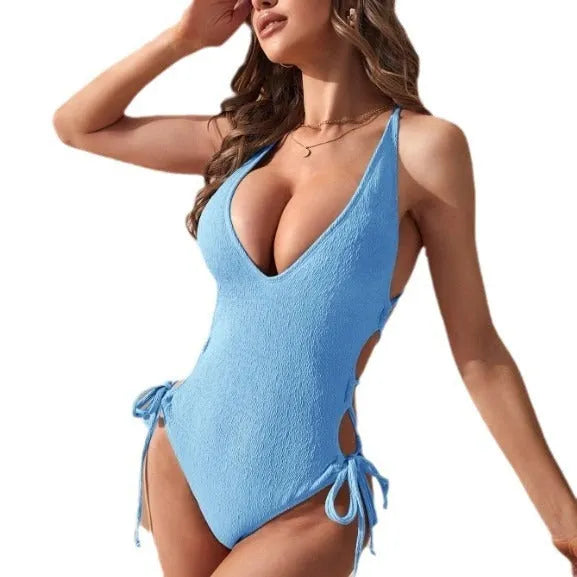 Women's hollow backless one-piece swimsuit in solid colour with tether straps.