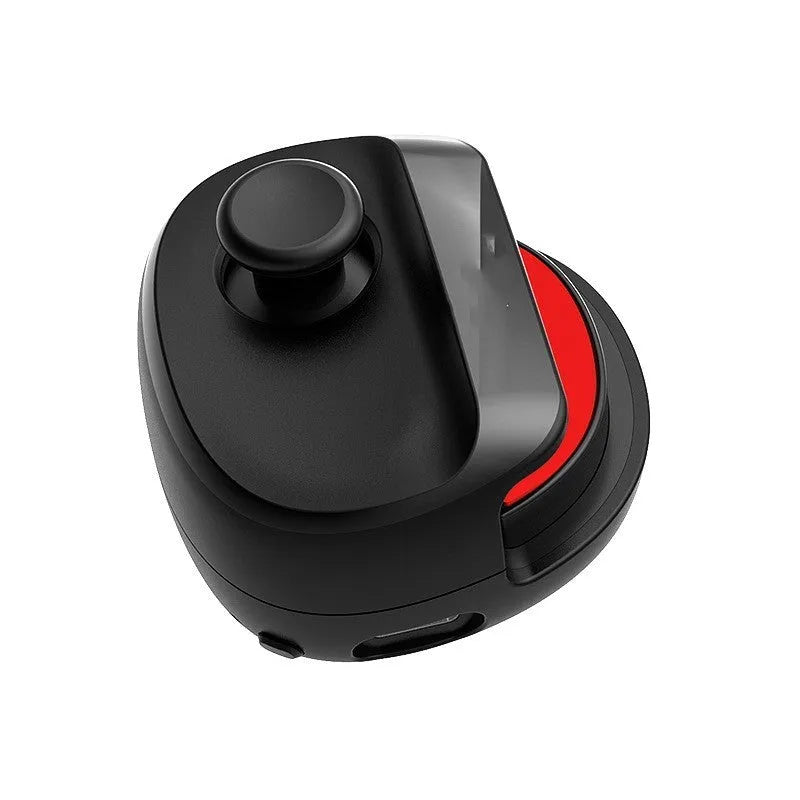 Black USB gaming stick controller on a desk next to a mobile phone