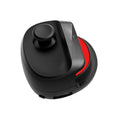 Black USB gaming stick controller on a desk next to a mobile phone