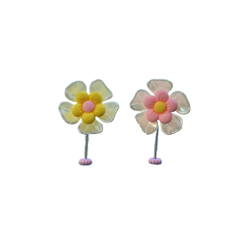 Small colourful plastic swing car decoration for hanging on rear view mirror.