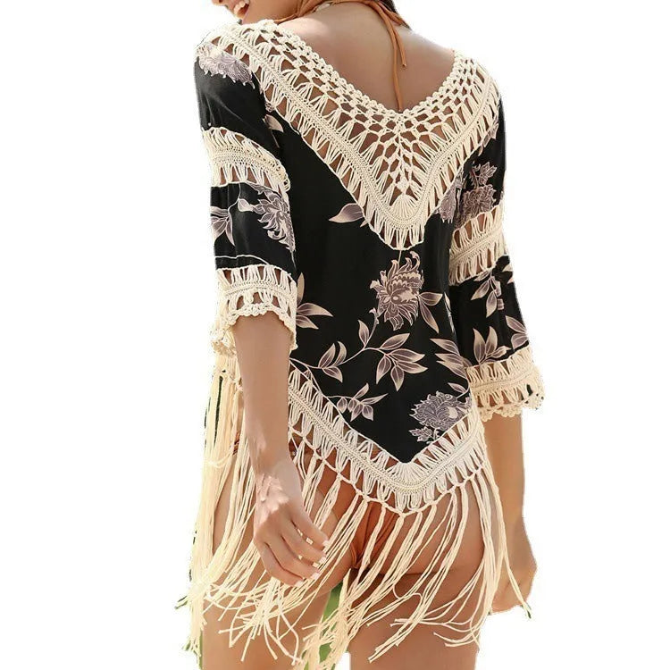 Apricot-coloured women's sun protection blouse with V-neck and hollow-out sleeves on a hanger.