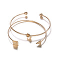 Women's gold vintage cuff bracelet with knotted arrow design in electroplated alloy