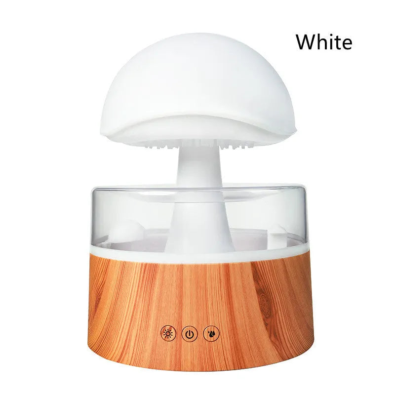 White cloud-shaped humidifier with raindrop simulation and colour-changing lights on wooden surface