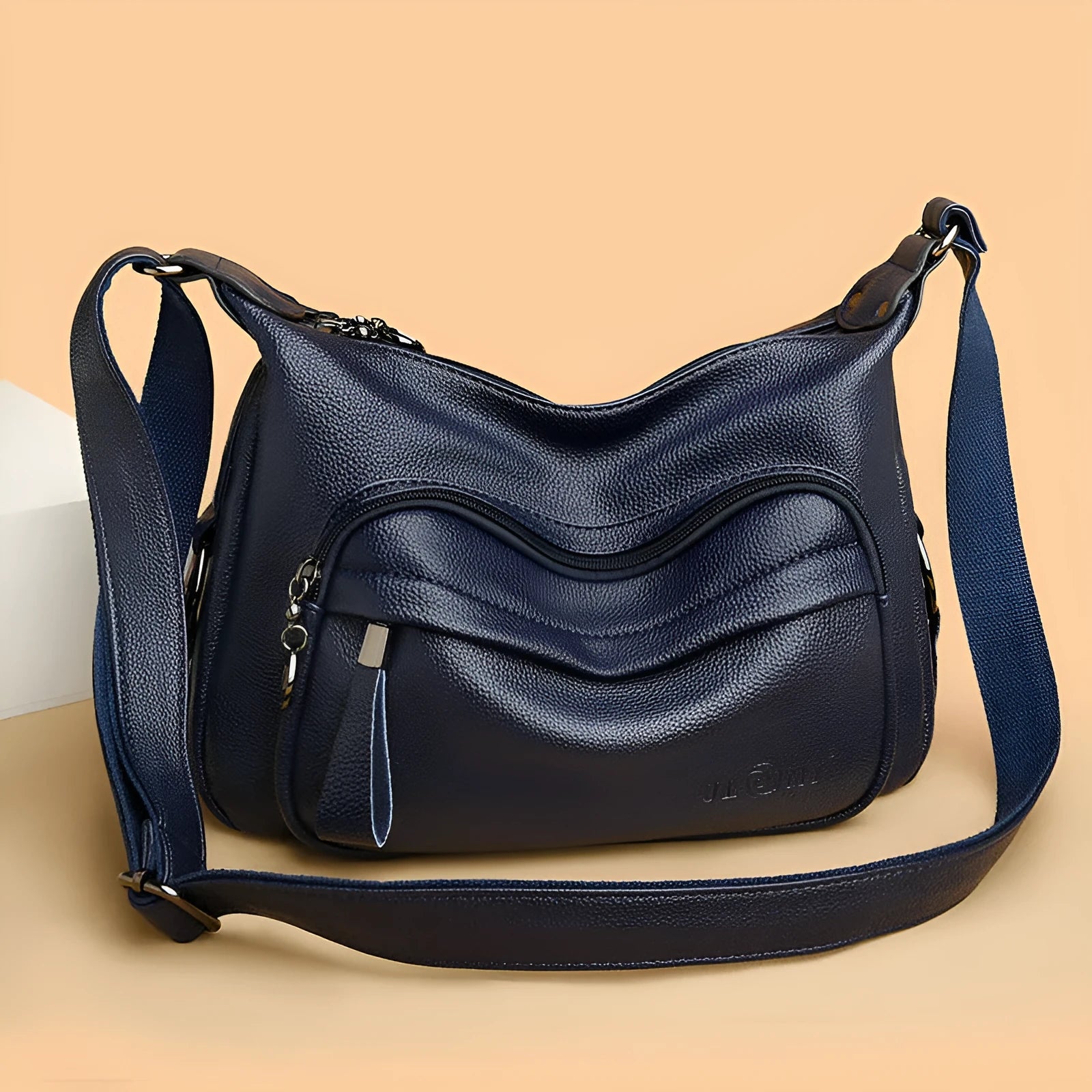 Large blue PU crossbody shoulder bag with multiple internal compartments and luggage-style design