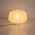 Japanese style xuan paper desk lamp with three-colour light source on a wooden desk in a bedroom