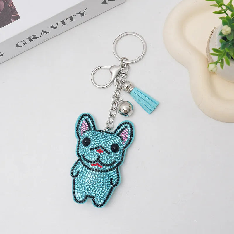 Cartoon dog alloy keychain pendant with rhinestones and bag tassel in caramel colour.