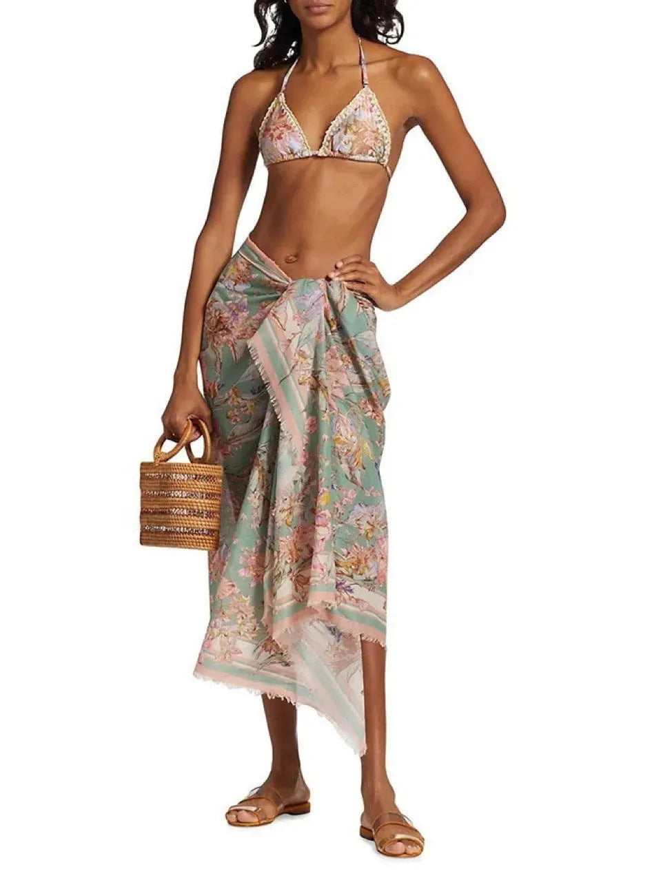 Women's beige floral bikini set with matching skirt on neutral background