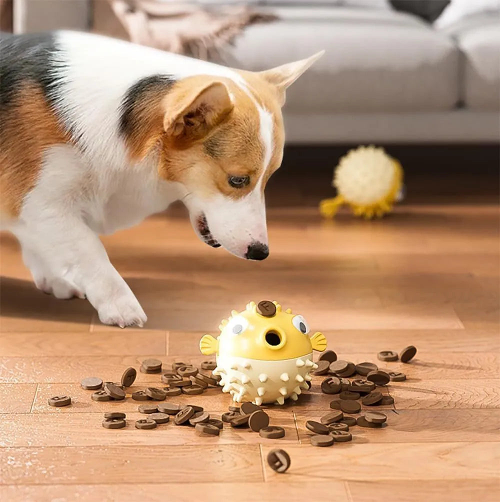Green fish-shaped dog toy with treat dispensing opening and textured surface for dental cleaning