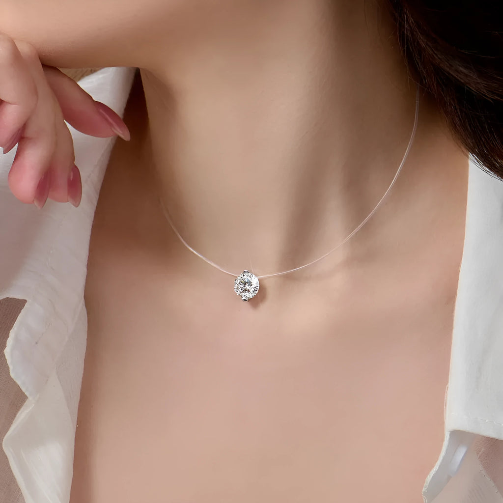 Close-up of a silver plum blossom pendant necklace with a moissanite stone set on an invisible fishing line.
