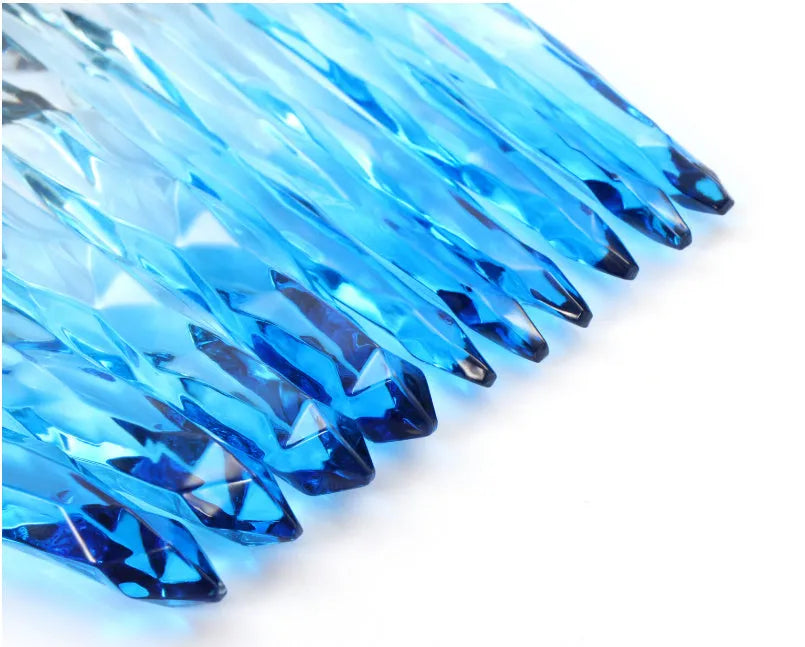 Ten crystal-handle foundation brushes with artificial fibre bristles in black, blue, red, and yellow colours.