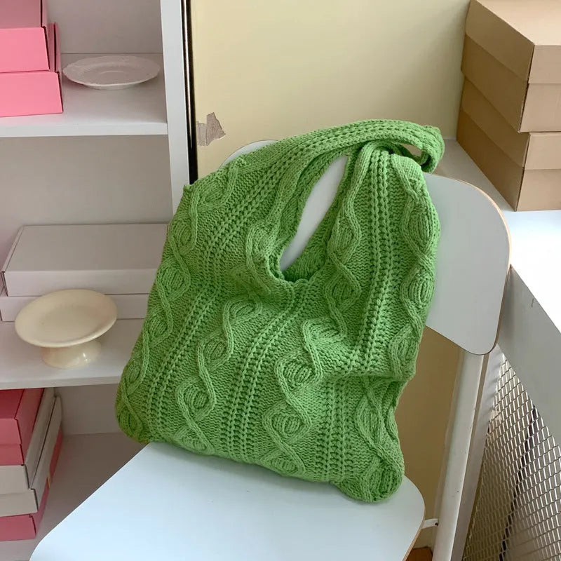 Women's retro-style hollow-knitted wool yarn tote bag in a solid colour, showing double shoulder straps.