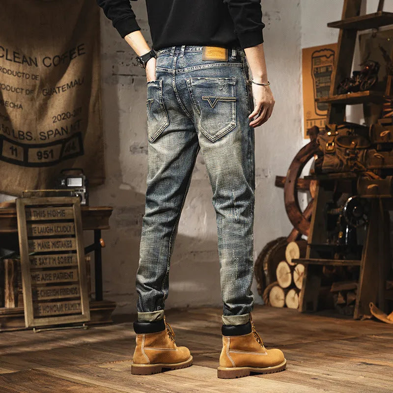 Man wearing vintage blue loose-fit jeans with a drawstring waist, showcasing the fleece-lined interior.