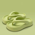 Women's thick-soled EVA flip-flops with a bow detail on the strap, shown in various colours.