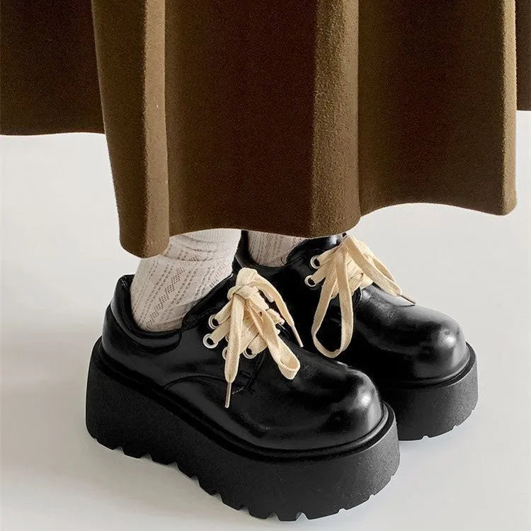 Matte black women's lace-up boots with thick rubber sole and English muffin heel