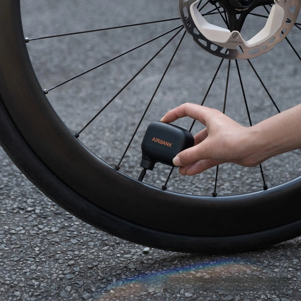 Black AS100 electric bicycle inflator pump with USB cable and waterproof storage bag