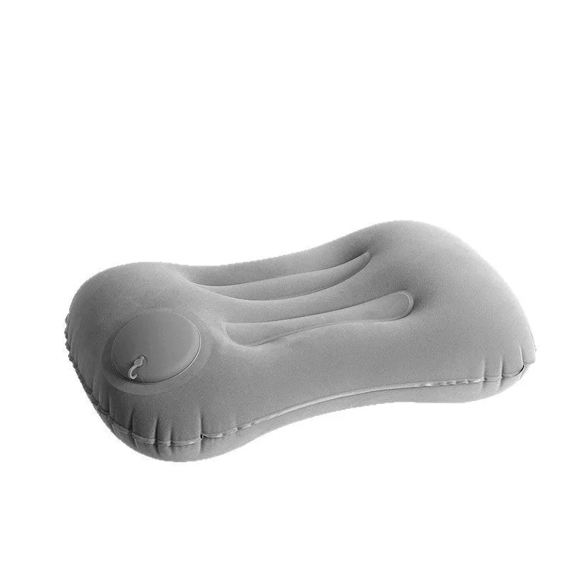 Grey flocking inflatable travel pillow showing compact rectangular shape and textured surface.