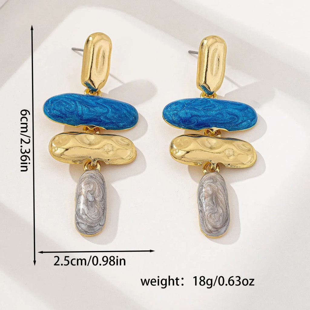 A pair of geometric-shaped stud earrings with a multicolour electroplated metal finish.
