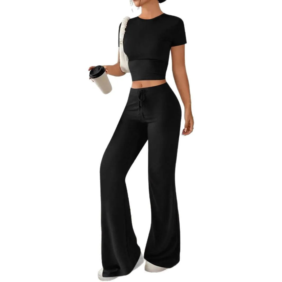 Black women's polyester tracksuit set with short sleeve top and high-waist trousers.