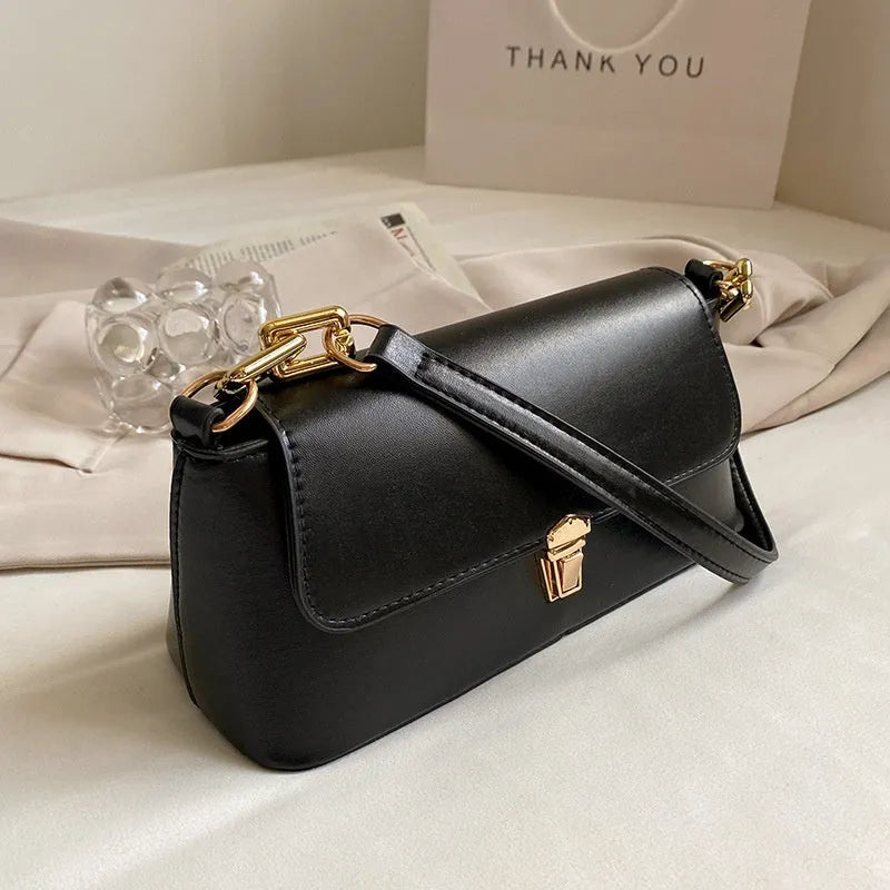 Brown French style casual underarm bag with a single shoulder chain, showing sandwich pocket and sewing thread detail.