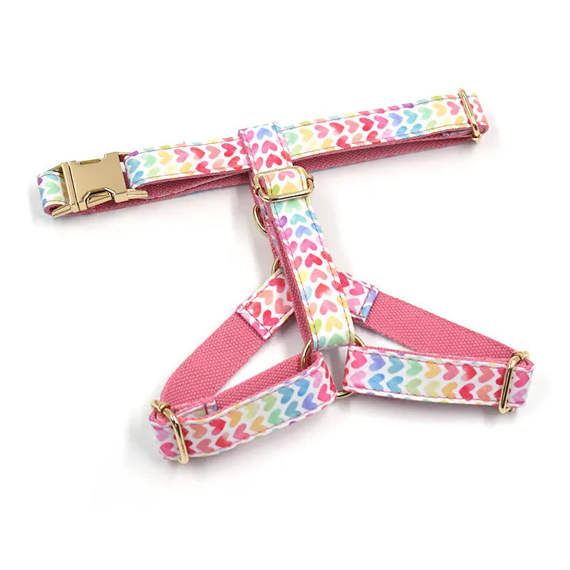 Pink dog harness with gold buckle and colourful heart-shaped stone decoration