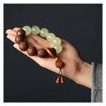 Rosewood bracelet with carved Fu character design showing 20mm beads on wrist