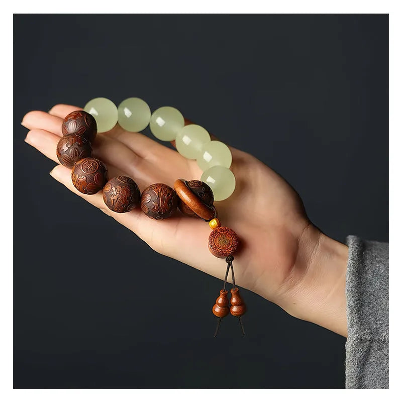Rosewood bracelet with carved Fu character design showing 20mm beads on wrist