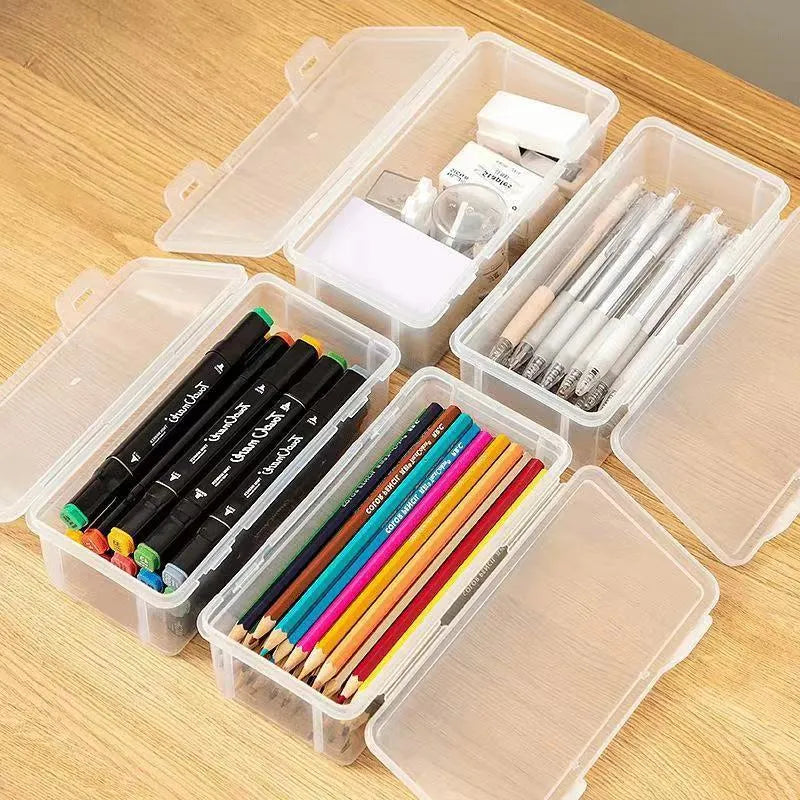 Transparent plastic stationery storage box containing colour pencils and drawing supplies