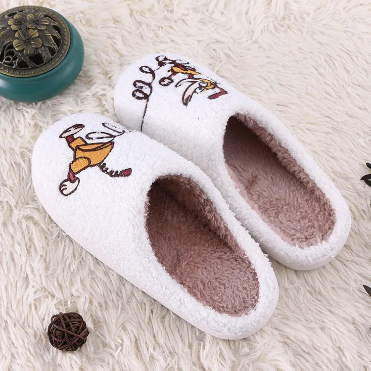 White fluffy slippers with cartoon pattern, rubber sole, and a toe holder design.