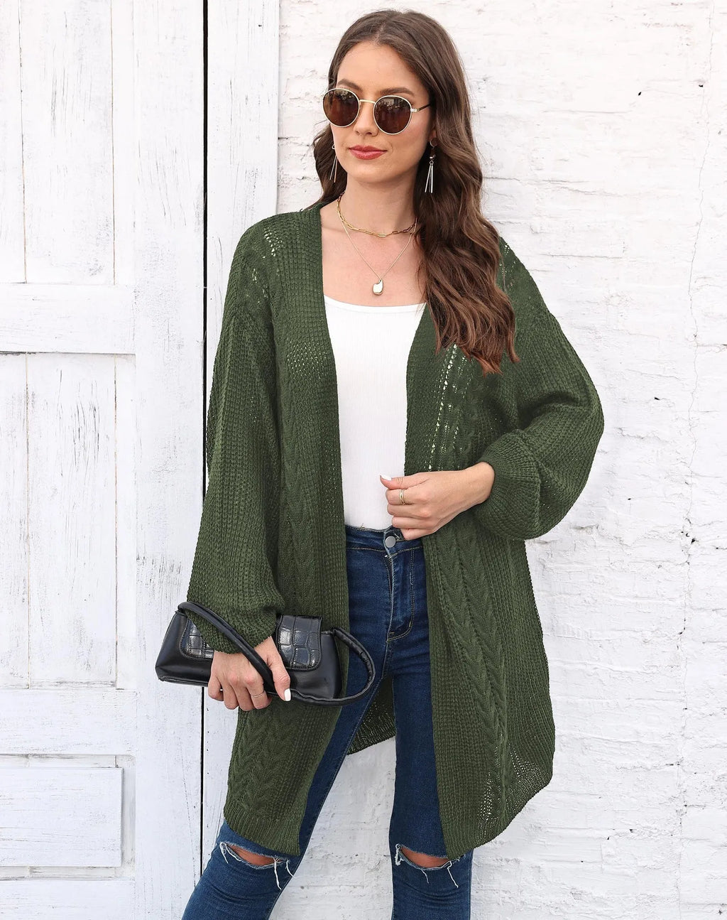 Women's loose brown acrylic sweater coat hanging, showing solid colour and knit texture.