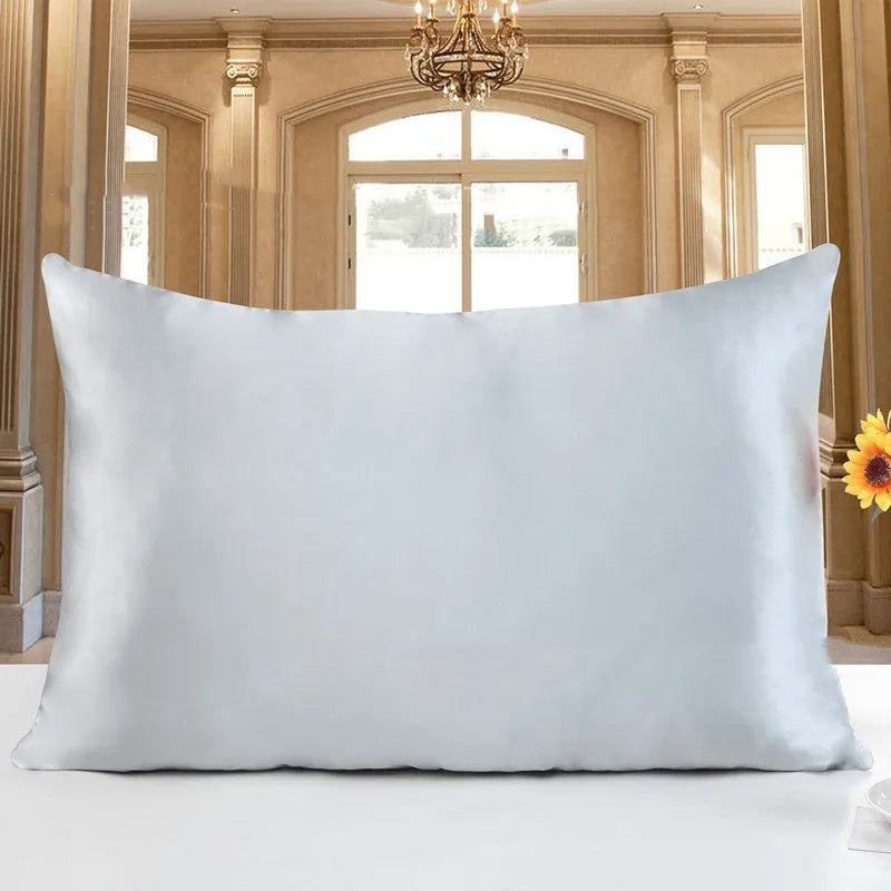 19 M double-sided silk pillowcase shown in one of 14 available colours, including apricot, sky blue, and black.