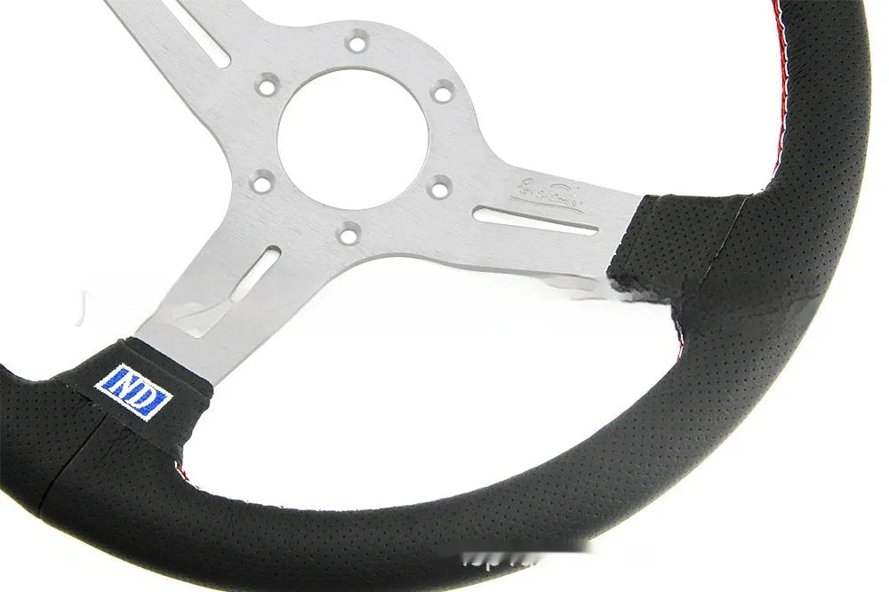 14-inch leather steering wheel with a concave rim and black metal skeleton spokes.