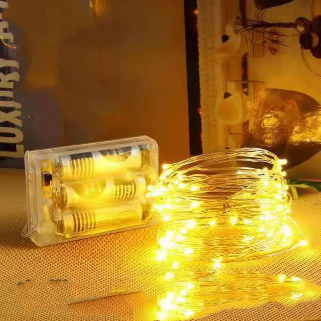 12-metre long flexible copper wire LED string light with 120 bulbs and a battery control box.