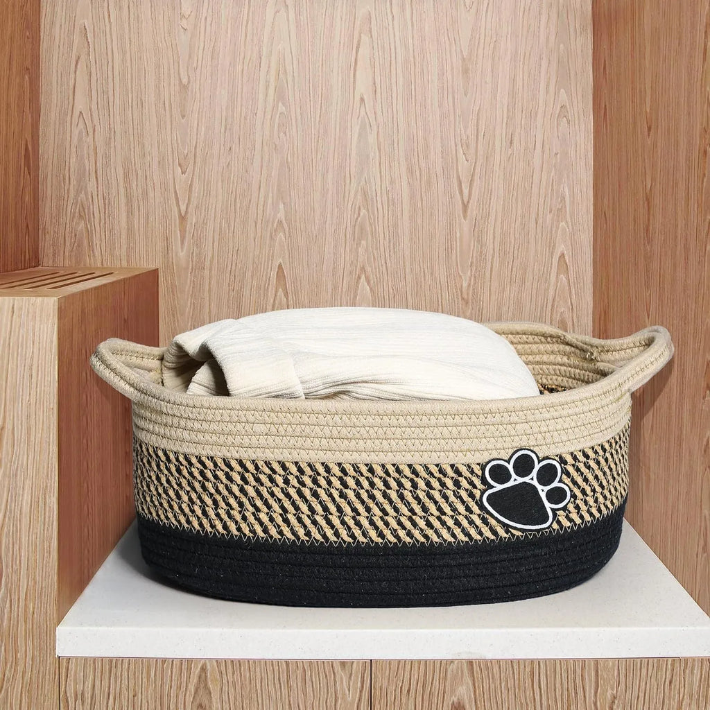 Small light beige woven cotton rope storage basket with a wooden handle.