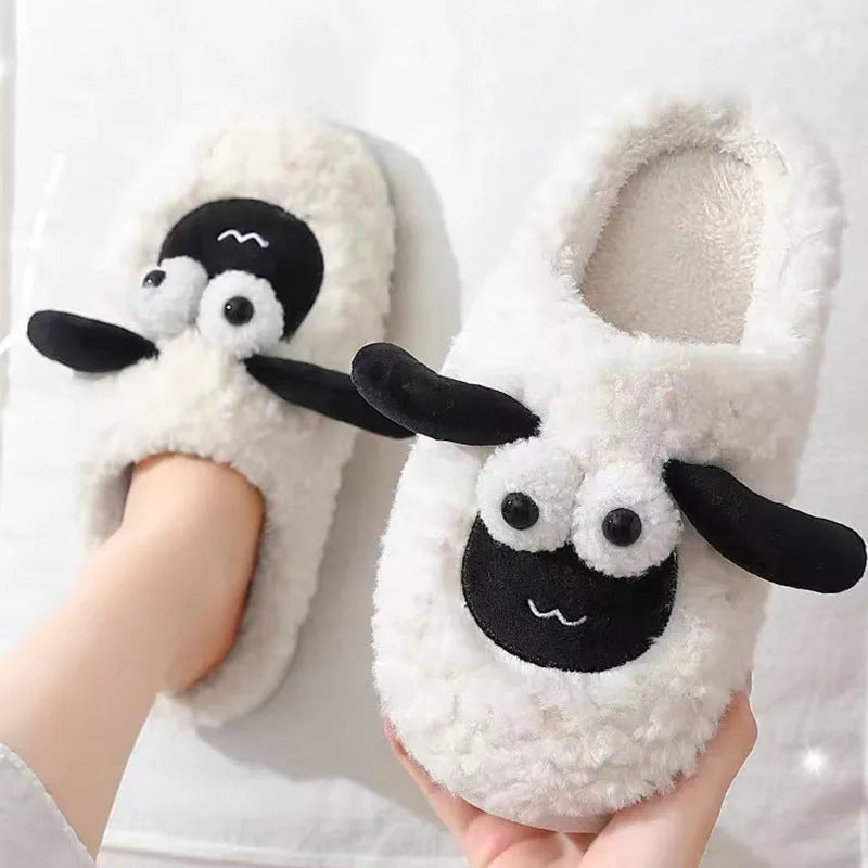 Brown lamb thermal cotton slip-on slippers with suede upper and PVC sole on a wooden floor.