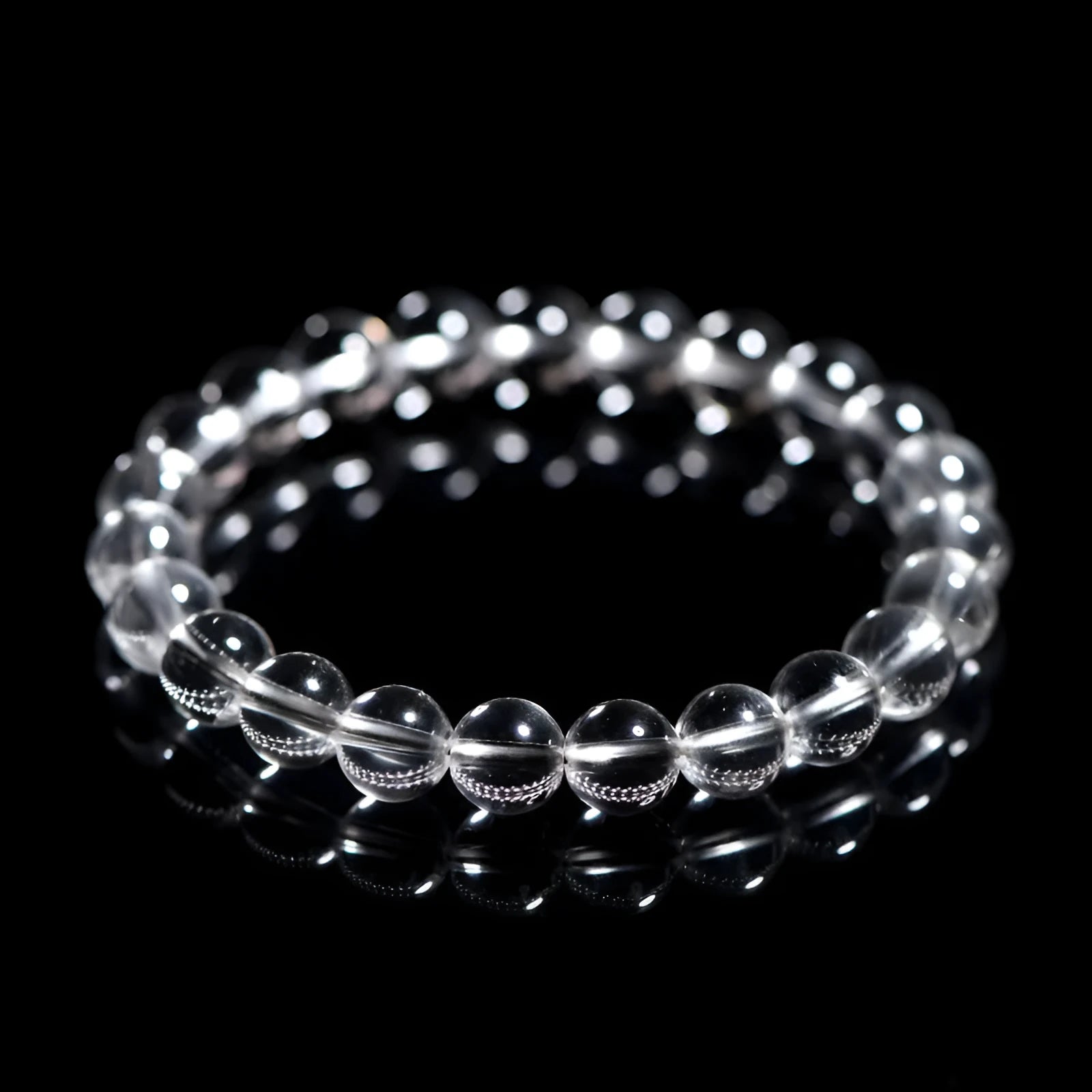 White crystal bracelet with round beads in various sizes from 6mm to 14mm diameter