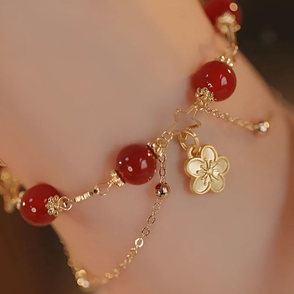 Red agate double layer women's bracelet with floral peach blossom charms on adjustable fastening