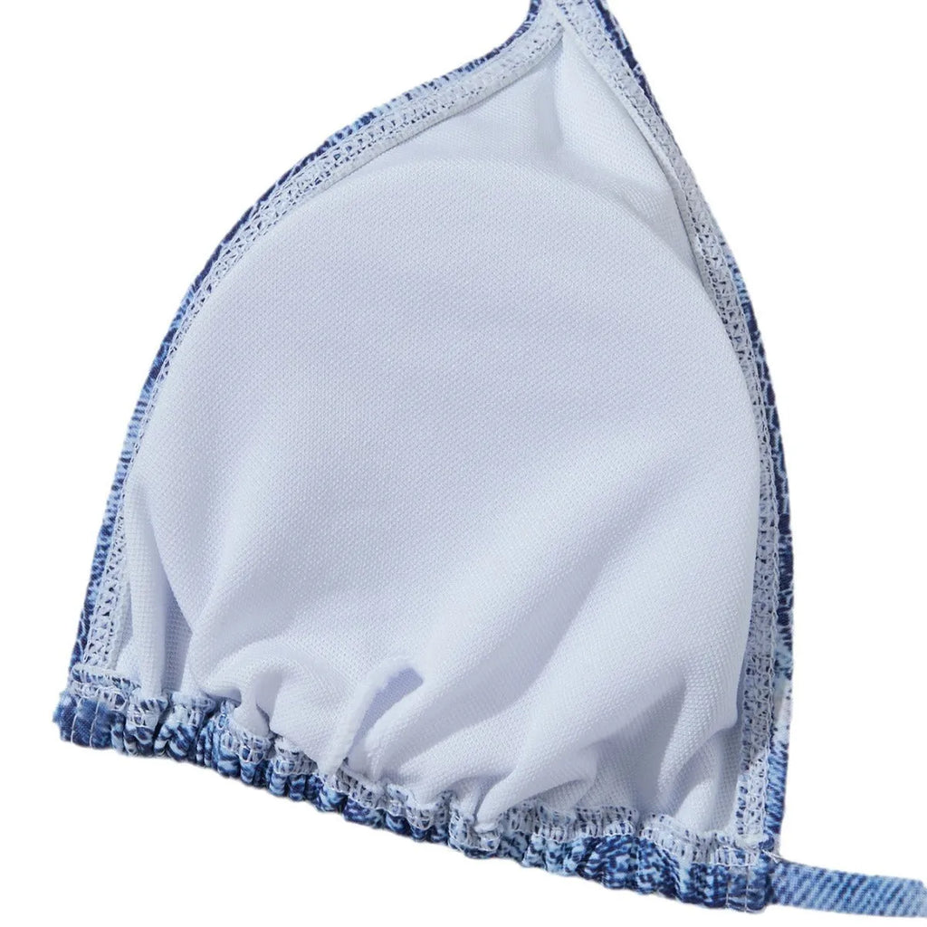 Denim blue women's bikini set with printed strap design on a hanger.