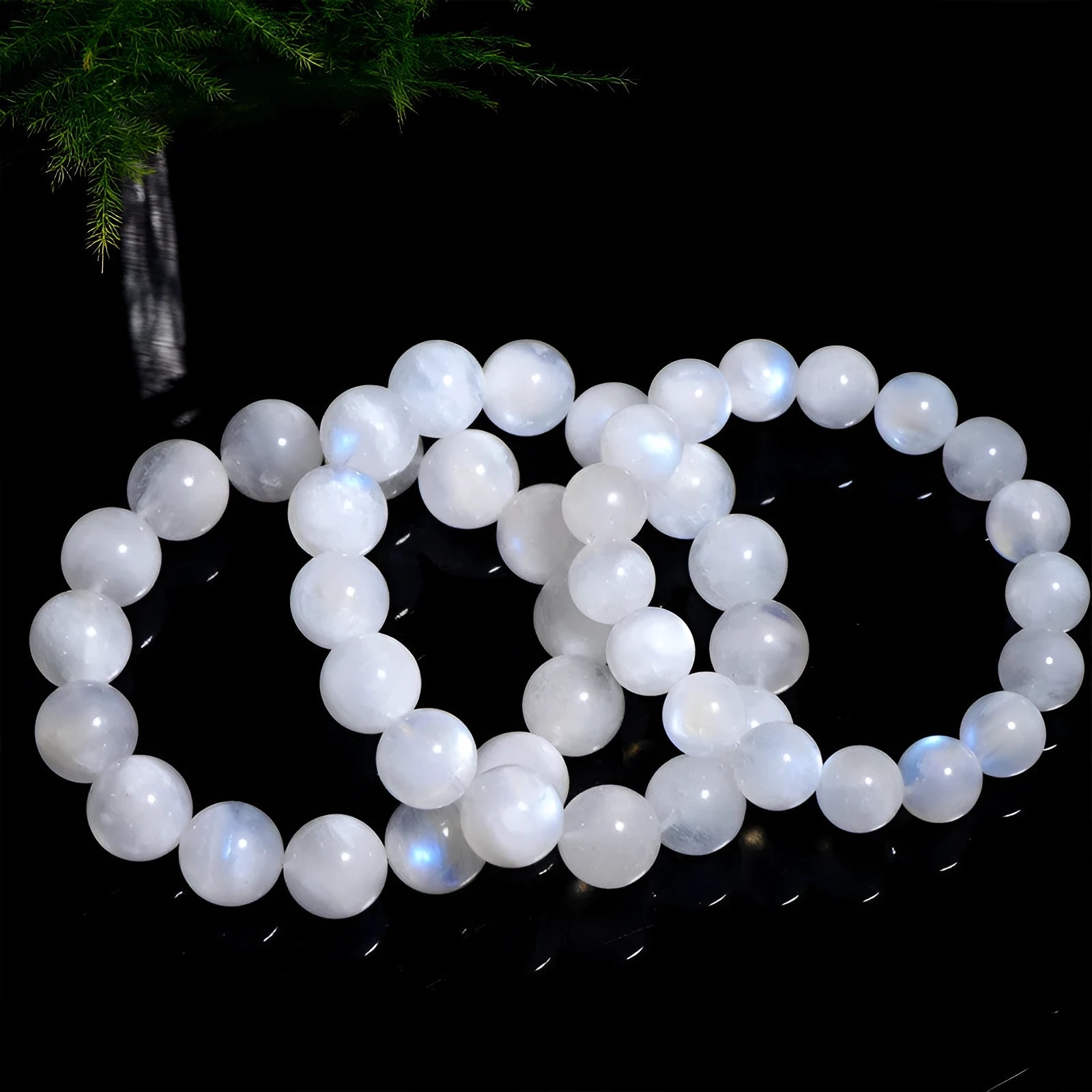 Polished moonstone bracelet with round blue beads showing natural colour variations