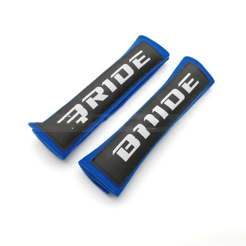 Car seat belt shoulder pad set in black, blue, or red colours with sponge padding and decorative embroidery