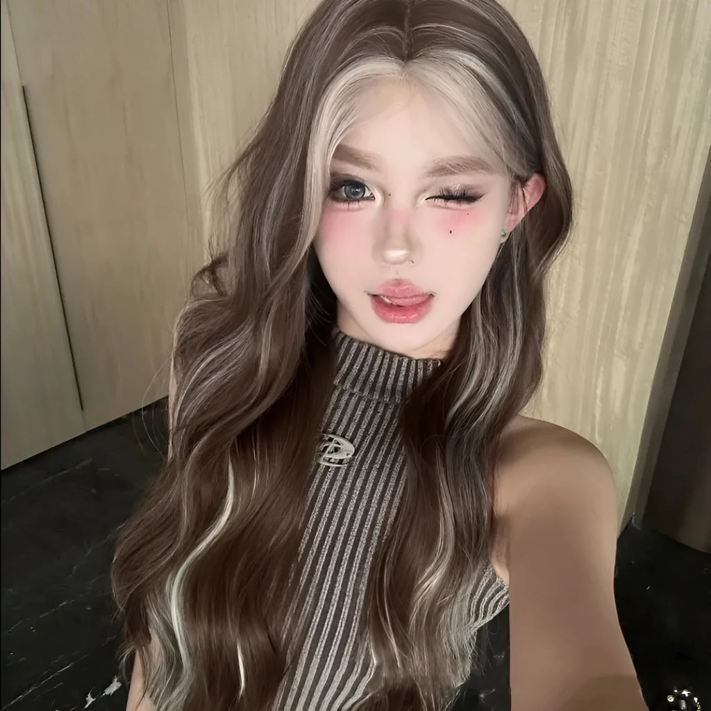 Long curly synthetic wig in gray gold with highlights, shown on a model.
