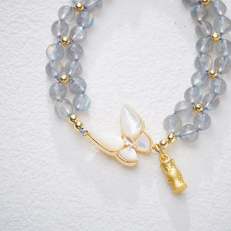 Handmade geometric woven bracelet for women with a grey moonstone and butterfly design.