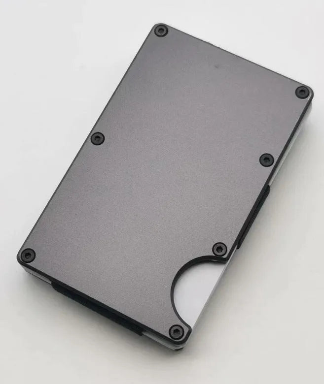 Carbon fibre credit card wallet in aluminium alloy grey, showing slim profile and card slots.